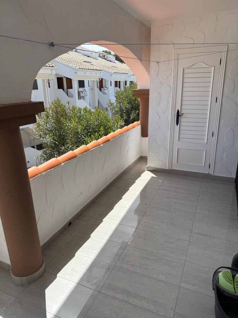 Terraza con arco y vistas hacia edificios de Pascua IV en Alcossebre